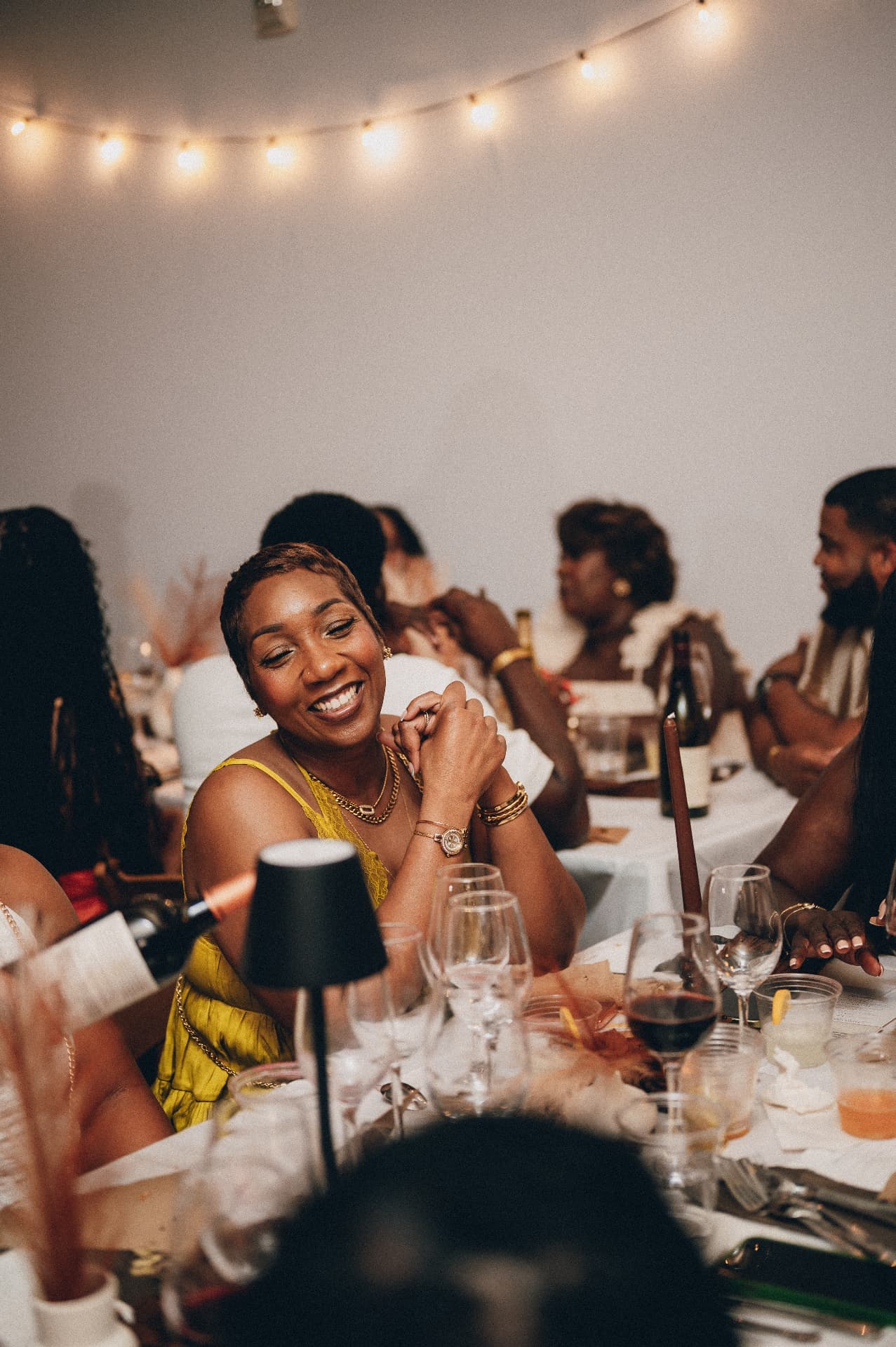 A guest smiling at the supper table
