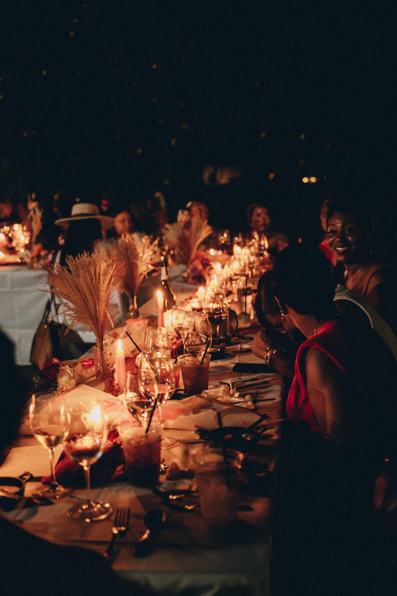 A candlelit Dirty Napkins dinner table at night